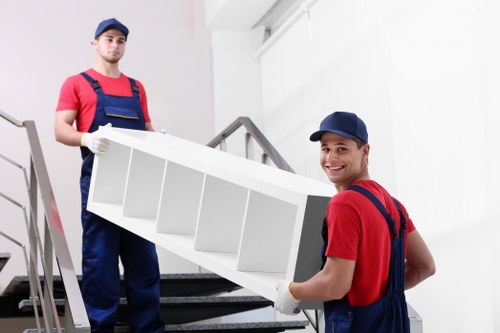 Packed moving boxes and furniture prepared for man with van removal