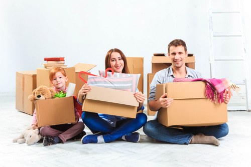 Professional movers handling household items in a Manor Park flat move