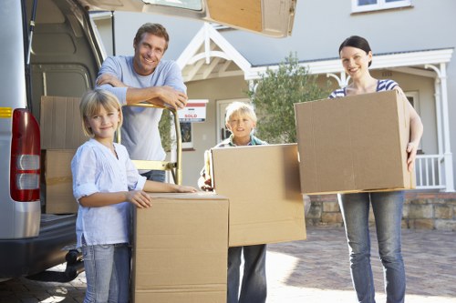 Team member handling packed boxes and furniture during transport