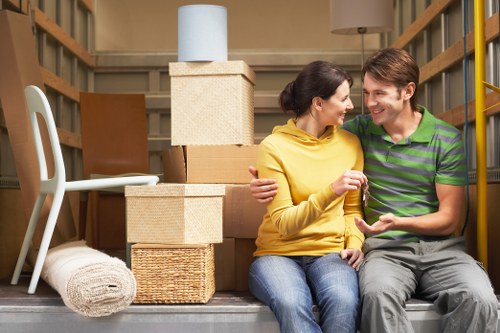 House removals team in Manorpark loading furniture carefully